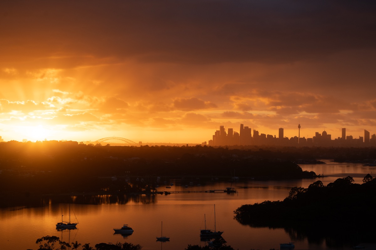 Sydney skyline glowing in orange twilight